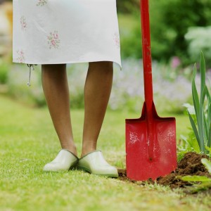 Close-up low section of woman holding spade